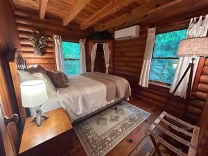 a bedroom with a bed in a log cabin at Ocoee Cabin Beautiful Cabin On The River's Edge in Ocoee