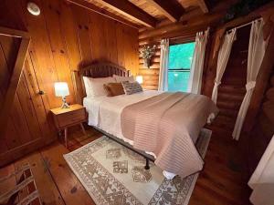 a bedroom with a bed in a log cabin at Ocoee Cabin Beautiful Cabin On The River's Edge in Ocoee