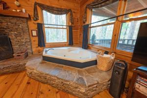 a jacuzzi tub in a log cabin at The Pines Riverside Log Cabin On The Ocoee in Ocoee +28 photos