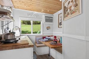 a kitchen with a table in a tiny caravan at Quail Run Farm- Rustic Tiny Home 1 in Chattanooga