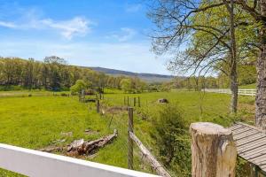 a field of green grass with a fence at Quail Run Farm- Rustic Tiny Home 1 in Chattanooga