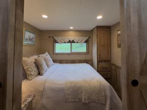 a bedroom with a bed in a small room at Quail Run Farm- Rustic Tiny Home 3 in Chattanooga