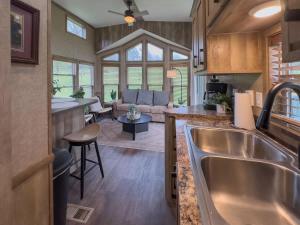 a kitchen and living room in a tiny house at Quail Run Farm- Rustic Tiny Home 3 in Chattanooga