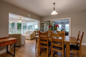 a dining room and living room with a table and chairs at An Grianán Getaway in Burt