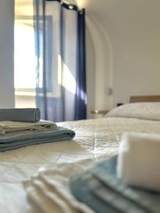 a bed with a blanket and a laptop on it at La Minicasa in Pacentro