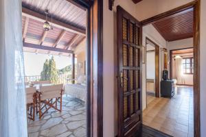 an open door to a living room with a table and a balcony at Guest House Sklithro in Sklíthron