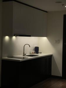 a kitchen with a sink and a counter with a light at Studio Sapphire Hạ Long View Biển in Ha Long
