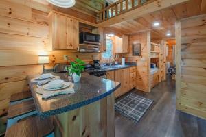 a kitchen with a large island in a wooden cabin at Thomas Cabin Forest Tiny Cabin With Hot Tub in Chattanooga