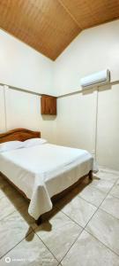 a bedroom with a white bed in a room at Casa el Corral #2 in Aguacate
