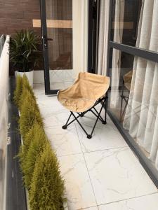 a chair sitting on a porch with plants at Ceilé Stay Đà Lạt in Da Lat