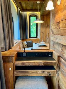 a room with a stove in the middle of a room at Luxus Chalet in Oberstaufen inkl Wellness Pool und Bergbahnen in Oberstaufen +17 photos