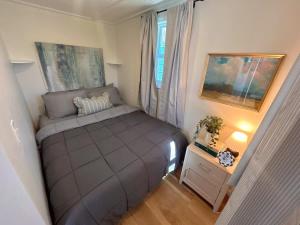a small bedroom with a bed and a window at Quail Run Farm- Rustic Tiny Home 2 in Chattanooga