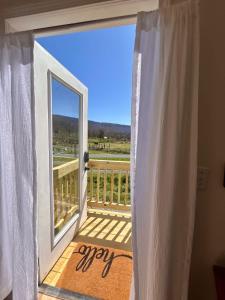 an open door to a balcony with a view at Quail Run Farm- Rustic Tiny Home 2 in Chattanooga