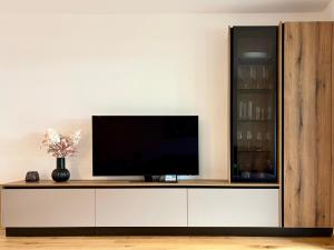 a flat screen tv sitting on top of a white cabinet at Apartment Lisa Hinterstoder in Hinterstoder