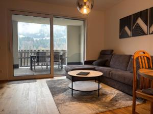 a living room with a couch and a table at Apartment Lisa Hinterstoder in Hinterstoder