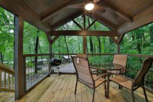 a screened porch with a table and chairs and a grill at Martha Cabin Tiny Cabin By Downtown Chattanooga in Chattanooga