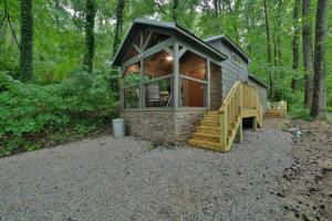 a small cabin in the woods with a large window at Martha Cabin Tiny Cabin By Downtown Chattanooga in Chattanooga