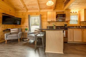 a kitchen with a counter and chairs in a cabin at Meg Cabin Tiny Rustic Comfort On Lookout Mtn in Chattanooga +31 photos