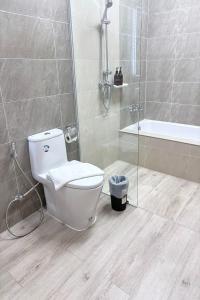 a bathroom with a toilet and a shower and a tub at BB house & resort in Ban Thum +13 photos