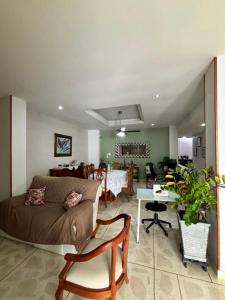 a living room with a couch and a table at Hostal El Recreo in Barranquilla