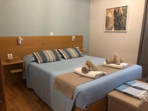 a bedroom with two beds with towels on them at Lemonaki House Lefkada in Asprogerakata