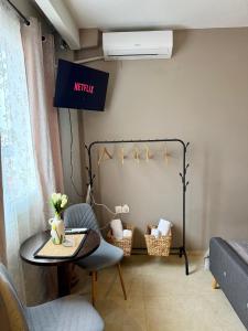 a table and chairs in a room with a heater at Sunny apartment in Serres