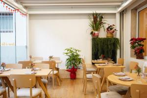 a restaurant with wooden tables and chairs and plants at Sunshine HOTEL in Mestre +52 photos