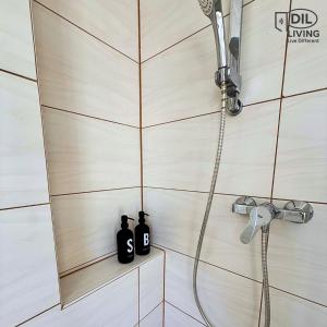 two black bottles sitting on a shelf in a shower at Modern - zentral - Studio mit Küche - Self Check In in Bad Nauheim