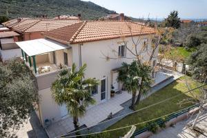 an aerial view of a house with palm trees at Villa Aurum in Prinos