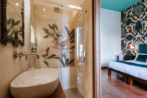 a bathroom with a shower with a sink and a toilet at Palazzo Giunta - Porta Marina Ortigia in Syracuse