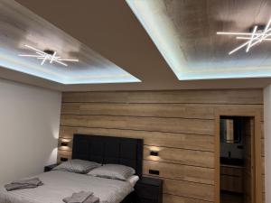 a bedroom with a bed and two ceiling fans at Villa White Stone in Starý Smokovec +106 photos