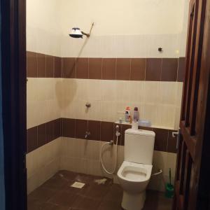 a bathroom with a toilet and a shower at Bamburi Mombasa two bedroom Cutraz homes apartments with swimming pool 005 in Mtwapa +6 photos
