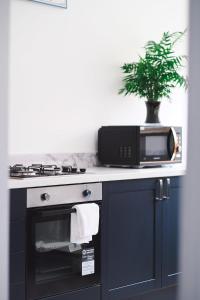 a microwave sitting on top of a stove in a kitchen at Sunrise Properties in Barnstaple