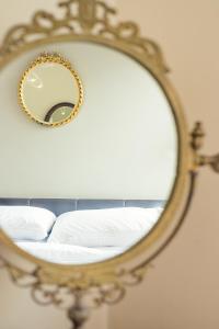 a mirror with a bed in a room at Regency Square Town House in Brighton & Hove