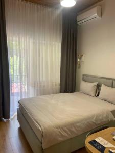 a bedroom with a large bed and a window at Hotel GLORIA in Ceadîr-Lunga +21 photos