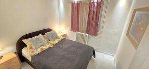 a small bedroom with a bed and a window at Urban Pool & Relax Apartment in Sarajevo +20 photos