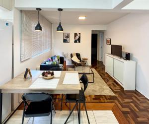 a kitchen and living room with a table and chairs at Barriga Verde in Florianópolis