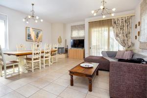 a living room with a couch and a table at Villa Aurum in Prinos