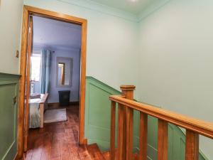 a hallway with a stairway leading to a room at 2 Rock View in Settle +18 photos