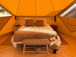 a bedroom in a tent with a bed and flowers at Lomas de Balsares in Elche +13 photos