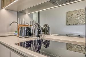 a kitchen with a sink and a mirror at Caica Executives at Ellipes 4202 in Midrand +19 photos