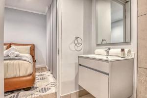 a bathroom with a sink and a mirror at Caica Executives at Ellipes 4202 in Midrand