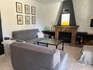 a living room with a couch and a fireplace at Casa Rural Tazgona in Antequera