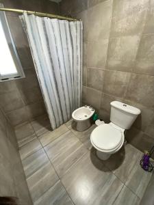 a bathroom with a toilet and a bidet at HastaLaRaíz-LosReartes in Los Reartes +2 photos