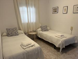 a room with two beds and a window at Casa Rural Tazgona in Antequera +18 photos
