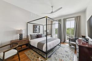 a bedroom with a bed and a desk and a chair at New Luxury Home Heated Pool & Spa in New Orleans