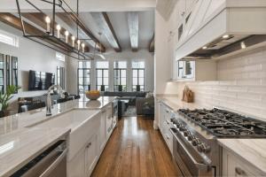 a kitchen with a sink and a stove at New Luxury Home Heated Pool & Spa in New Orleans