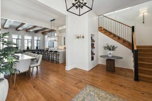 a living room with a staircase and a dining room at New Luxury Home Heated Pool & Spa in New Orleans