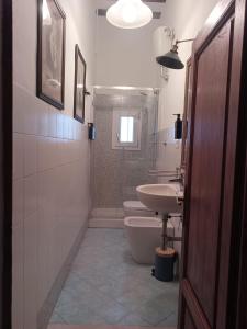 a bathroom with a sink and a toilet and a shower at 2ª Casa del Borgo Antico in Poggibonsi