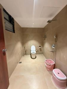 a bathroom with a toilet and a sink at 7 Tree Resort & Restaurant in Pune